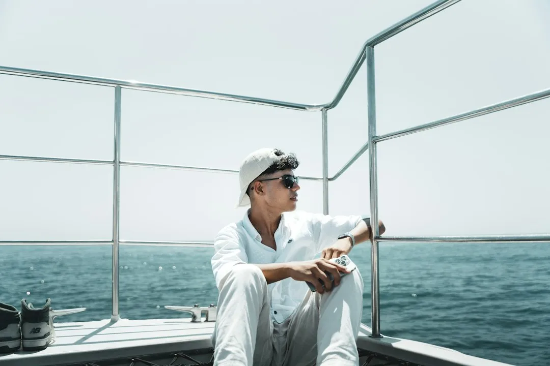 A man sitting on a boat in the water