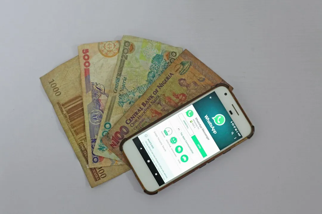 white Android smartphone beside banknotes