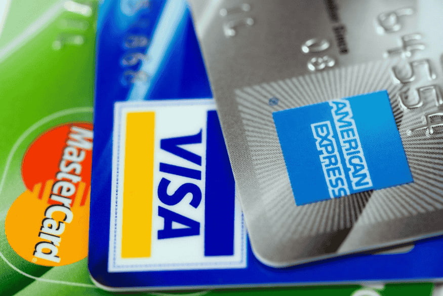 Tarjetas de crédito de marcas como Visa, Mastercard y American Express superpuestas.